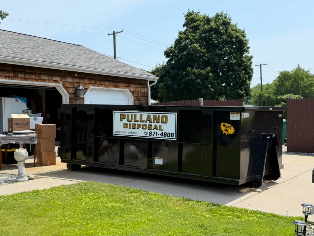 Pullano Disposal dumpster in a residential driveway